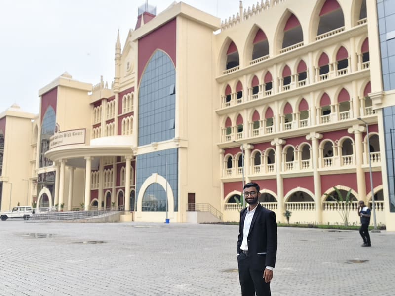 Satyajit Paul in a suit in front of the Circuit Bench building at Jalpaiguri