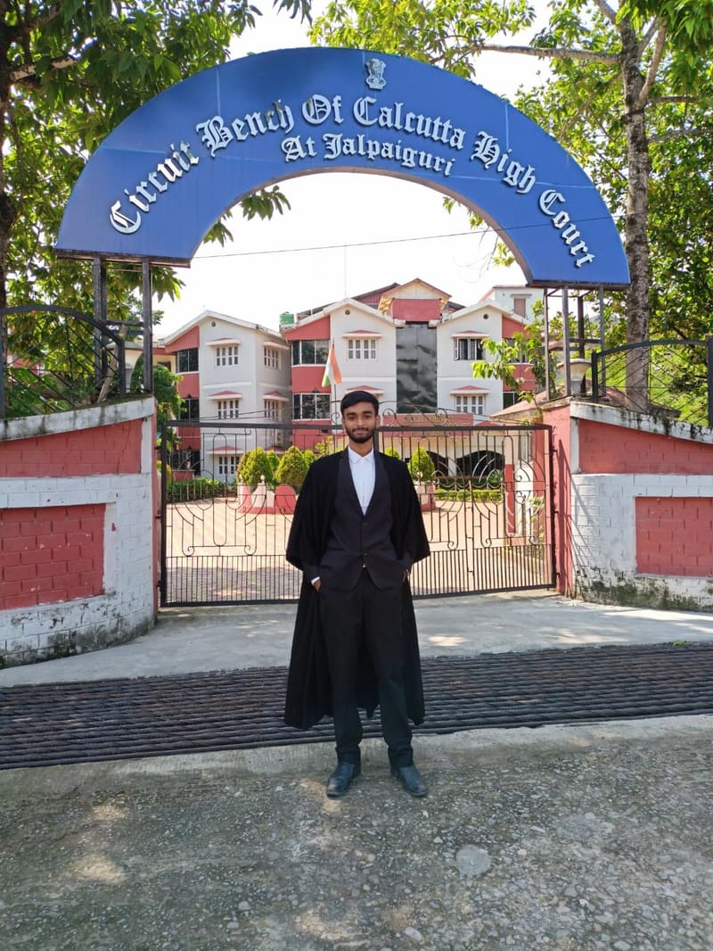 Satyajit Paul standing under the entrance arch of the Circuit Bench of Calcutta High Court at Jalpaiguri
