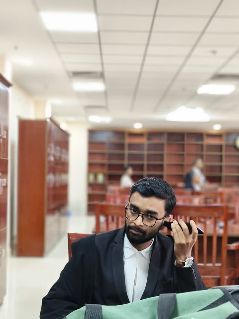 Satyajit Paul in advocate's gown on the telephone in the bar library
